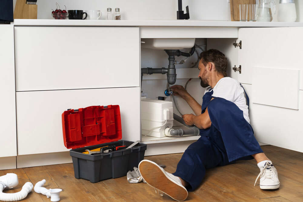 Skilled Plumber Unclogging A Bathroom Sink